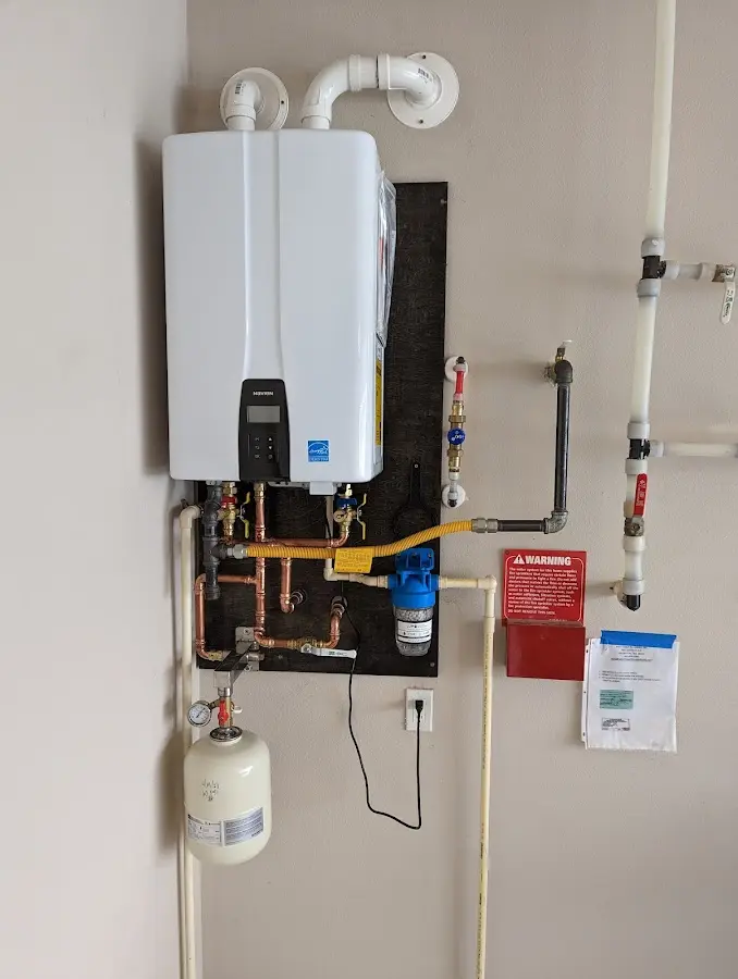 Professional plumber installing copper piping in a Vadnais Heights home